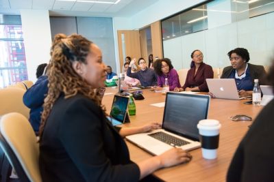 diverse professionals sitting at a table in a conference room engaged in discussion